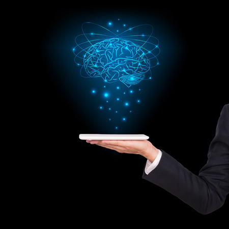 Close-up of business man brain with tablet in handの写真素材