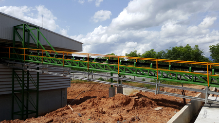 wood chips transport by conveyor belt to wood chips fuel storehouseの写真素材