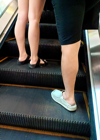 People on escalator going up to the fourth floor in department store