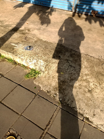 Women Shadows : woman's waiting for a bus at the bus stopの写真素材