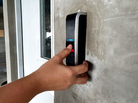 Woman Using Biometric Fingerprint Scanner For Security System