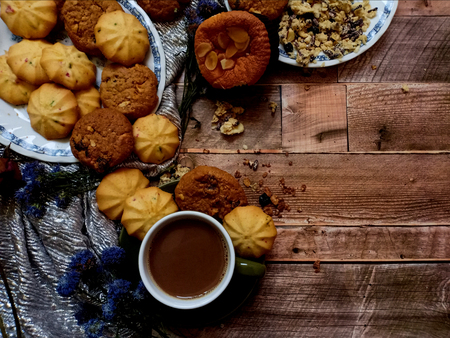 Oatmeal raisin cookies, fruit cookies with cup of coffee on wooden backgroundの写真素材