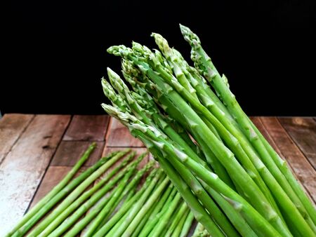 Fresh green asparagus on wooden table.の写真素材