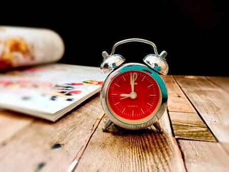 Alarm clock on wooden table.