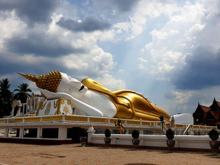 Reclining Buddha on nimbus clouds in the sky background at Wat That Noi in Nakhon Si Thammarat, Thailandの写真素材