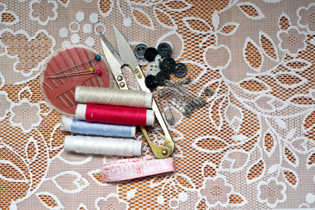 Pants sewing tools by hand.Thread needle, scissors, brooch, button, strap.