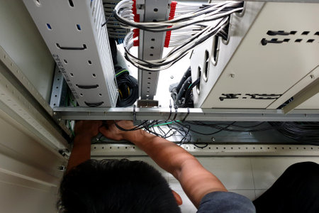 A Worker sealing the floor of the electrical control cubicle.の写真素材