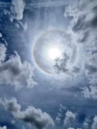 The sun halo with cloud in the sky on midday.