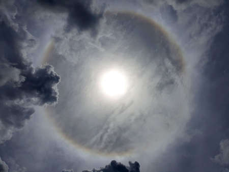 The sun halo with nimbus cloud in the sky on midday.
