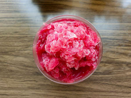 Glass of beetroot with passion fruit juice on wooden tables background.