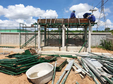 Construction workers doing work structure of building in the factory.