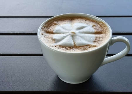 Sideway shop coffee, a cup of hot latte art coffee on wooden background.の写真素材