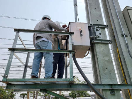 The electrical technician opens the 115kV Load Break Switch control cubicle for operation.