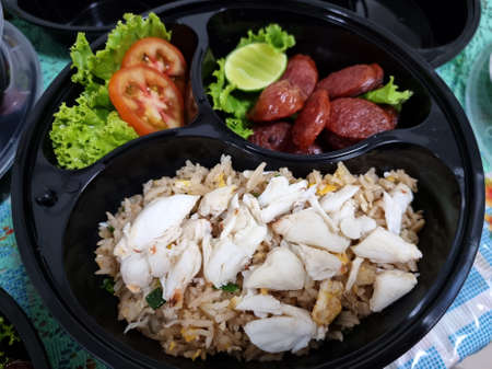 The crab meat fried rice with chinese sausage and vegetable in the packaging food.の写真素材