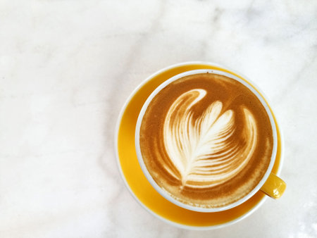 A cup of hot latte art simple tulip coffee on the tableの写真素材
