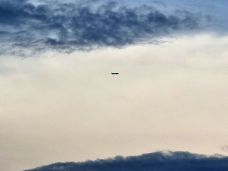 Airplane flying over the clouds in the sky backgrounds
