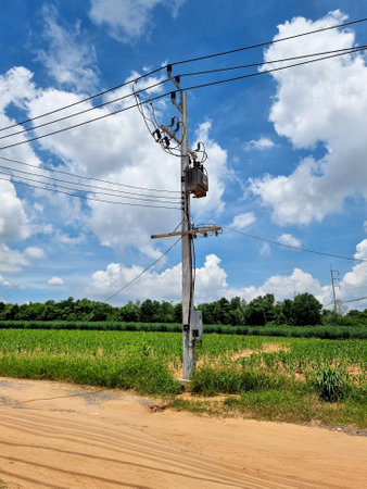 The transformer installed by Pole Mounted for utility in the blue sky background.の写真素材