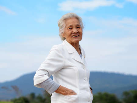 Healthy Asian senior woman enjoying her day outdoors