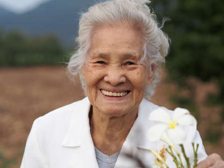 Healthy Asian senior woman enjoying her day outdoors