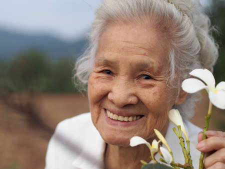 Healthy Asian senior woman enjoying her day outdoorsのeditorial素材