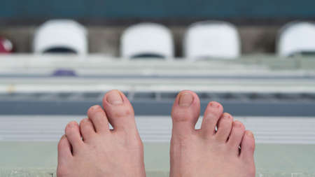 Feet hanging by the edge of a buildingの写真素材
