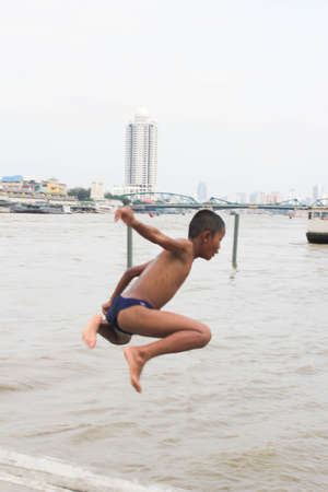 1 October, 2011 - Bangkok, Thailand:Boys playing in Chaopraya riverのeditorial素材