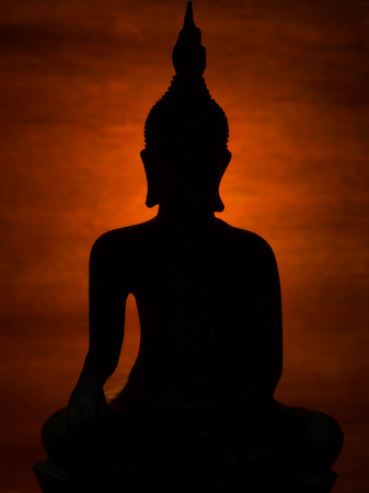 Buddha Statue in the shadows and Light of Dharmaの写真素材