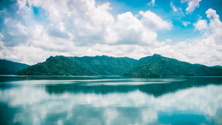clouds and blue sky with Mountain and Lake of Khundanprakanchon dam, Nakhon Nayok, Thailandの写真素材