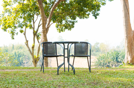 table with chairs standing on the gardenの写真素材