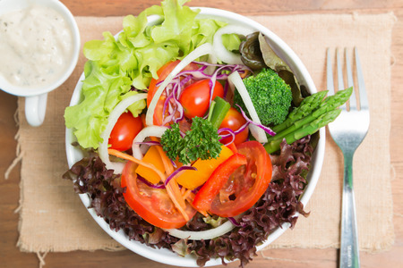 fresh vegetable salad on wood backgroundの写真素材