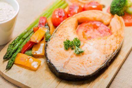 Salmon steak grilled with vegetable and Sour Cream Sauceの写真素材