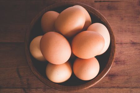 top view of eggs in bowl wooden on wood tableの写真素材
