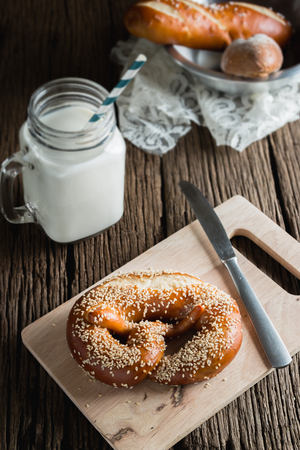 Fresh bread with milk on wooden groundの写真素材