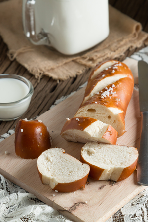 Fresh bread with milk on wooden groundの写真素材