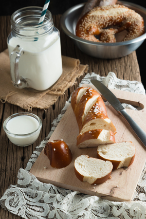 Fresh bread with milk on wooden groundの写真素材