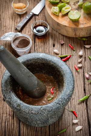 shrimp paste chilli sauce in a mortar stone with Ingredients to cookの写真素材