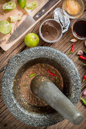 Shrimp paste chilli sauce in a mortar stone with Ingredients to cookの写真素材