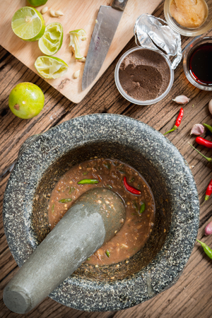 Shrimp paste chilli sauce in a mortar stone with Ingredients to cookの写真素材