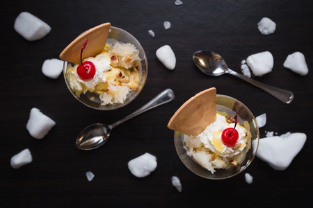 Durian ice cream with cherry and Waffle on black wood backgroundの写真素材