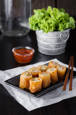 thai spring rolls with sauce on wooden backgroundの写真素材