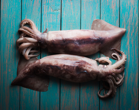 raw squid on wooden table close-upの写真素材