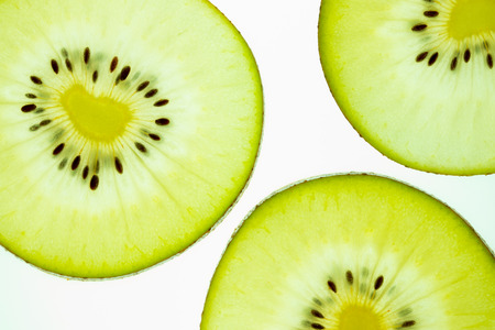 kiwi fruit slice, close up macro shot, isolated on white backgroundの写真素材