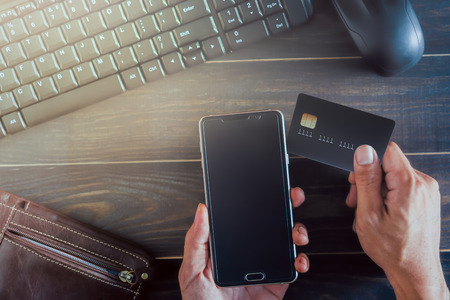Hands holding smart phone with credit card  and wallet for Online shopping