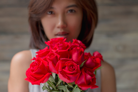 woman holding red roseの写真素材