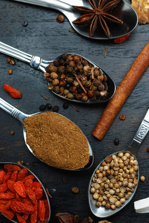 Spices and herbs on black wood backgroundの写真素材