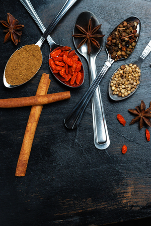 Spices and herbs on black wood backgroundの写真素材