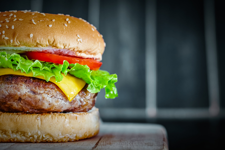 Tasty grilled beef Burger on wood backgroundの写真素材