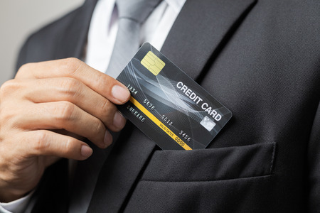Men take out the credit card from the suit pocket.の写真素材