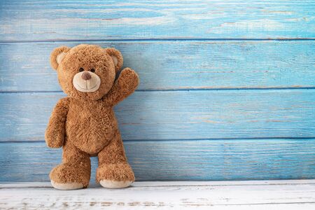 Cute teddy bear with copy space on blue color wood background.の写真素材