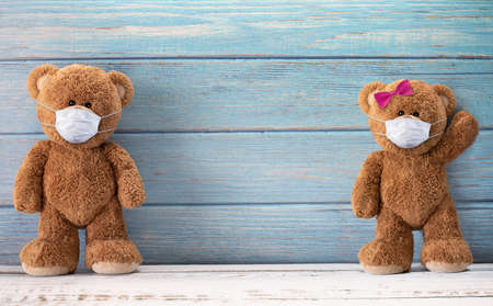 Cute teddy bears smiling behind the mask have a happy face for social distancing concept. with copy space.の写真素材